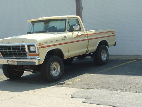 1993 Ford Taurus - This 1977 Ford F-Series pickup truck features a distinctive grille and side stripe detailing.