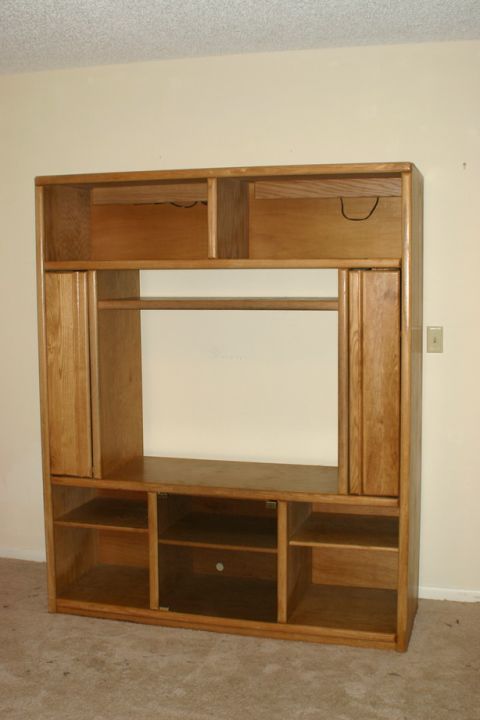 2003 Jeep TJ - A large wooden entertainment center with multiple shelves and cabinets is shown in a room.