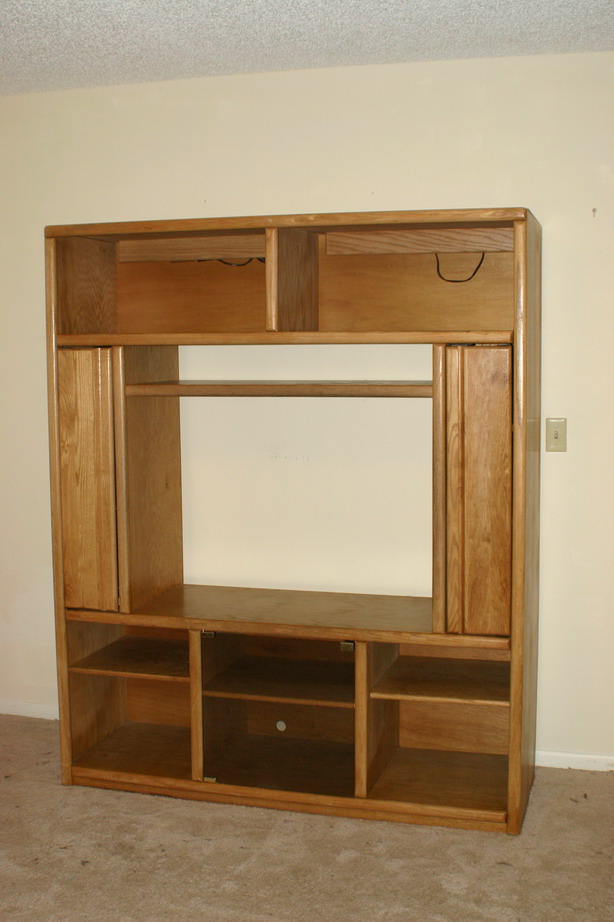 Wooden entertainment center with shelves and cabinets