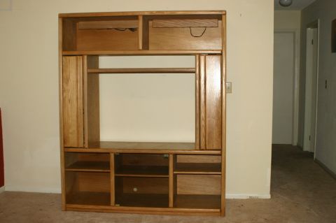 2003 Jeep TJ - A wooden entertainment center is shown in a room with carpeted flooring.