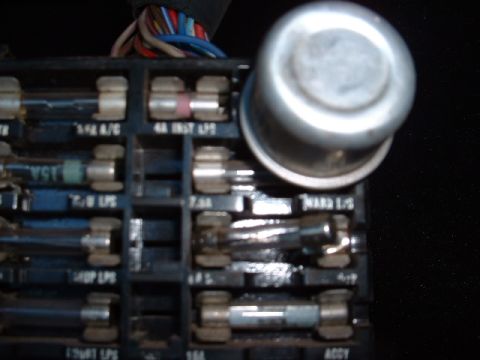 1978 Ford Mustang II - A detailed view of a vehicle's interior fuse box, showing multiple fuses and electrical connections.