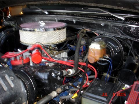 1979 Ford F-250 - Close-up view of a vehicle's engine bay, a prominent chrome air cleaner and numerous red wires.