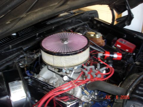 1979 Ford F-250 - The engine bay features a prominent aftermarket air filter and red spark plug wires.
