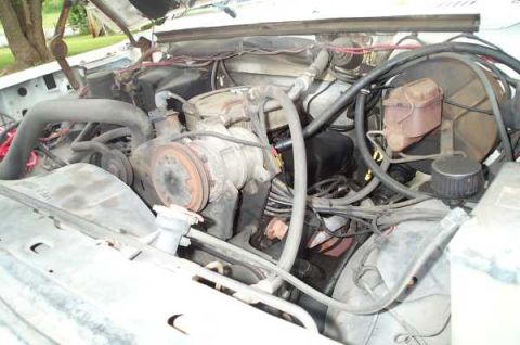 1985 Ford Bronco - Close-up view of an engine bay, showing various mechanical parts and wiring.