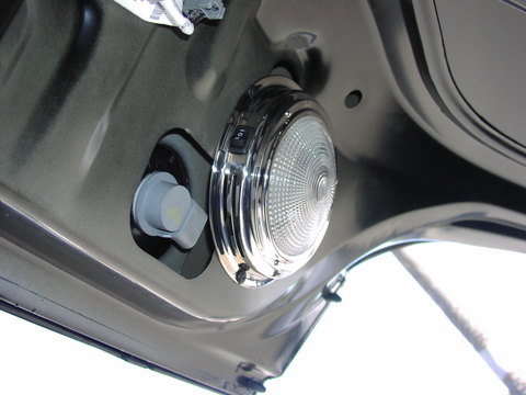 2000 Ford Crown Victoria - Trunk light assembly showing chrome bezel and bulb socket.