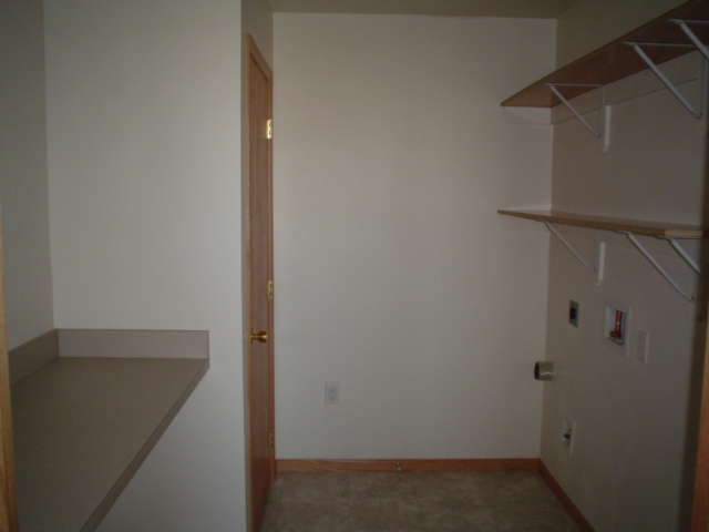 Laundry room, contains a folding table (!!!!!) and room for a second fridge, with plug behind it!!  We have our stand up freezer in there.