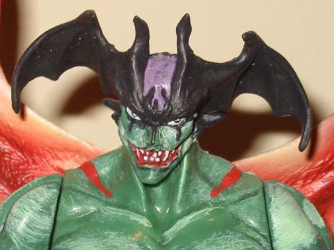 1991 Ford Bronco - This is a close-up of a green action figure with black horns and red wings.