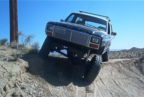 1986 Ford Bronco - This 1986 Ford Bronco is captured mid-climb on a challenging off-road trail.