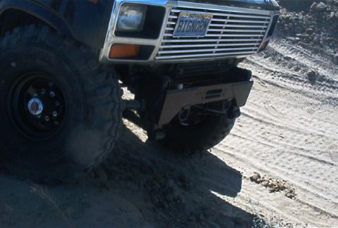 1986 Ford Bronco - Front view of a 1986 Ford Bronco with a custom bumper off-road.