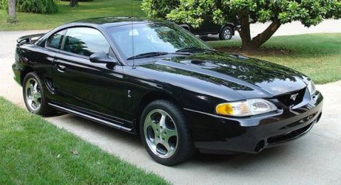1988 Ford Bronco - This black 1996 Ford Mustang coupe is seen from a 3/4 front angle, with a spoiler on the rear deck.