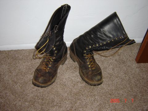 1993 Ford Bronco - A pair of well-used work boots are shown resting on a carpeted surface.