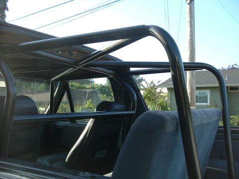 1989 Ford Bronco - Interior view of a 1989 Ford Bronco, highlighting its custom roll cage and seating.
