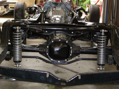 1967 Pontiac GTO - The chassis and powertrain of a car are shown, with the rear axle and suspension prominently displayed.