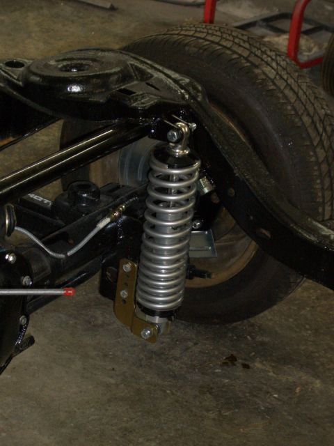 1967 Pontiac GTO - Close-up view of a vehicle's rear suspension system, highlighting the shock absorber and tire.