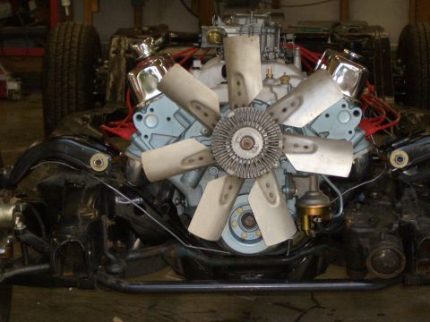 1967 Pontiac GTO - Close-up view of an engine assembly with visible fan and carburetor, mounted on a chassis.