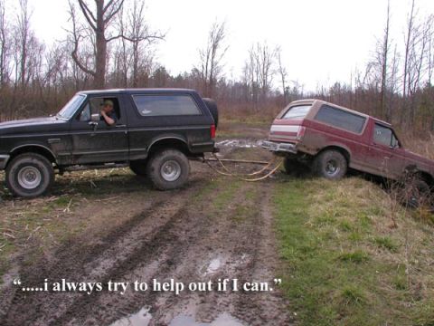 1988 Ford Bronco - A black 1987 Ford Bronco tows a maroon Bronco out of a muddy ditch, with the driver of the black Bronco stating, ".....i always try to help…