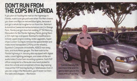 2000 Ford Crown Victoria - A silver 2000 Ford Crown Victoria is shown from the front-right, with a person standing beside it.