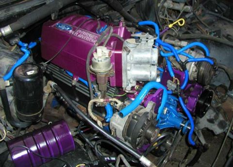 1988 Ford Bronco - Engine bay components, including a purple intake manifold and blue hoses, are visible.