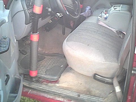 1994 Ford Bronco - The interior of a 1994 Ford Bronco is visible, the passenger seat, dashboard, and floor mats.
