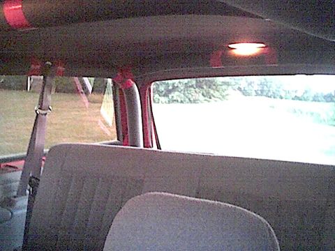 1994 Ford Bronco - Looking forward from the rear seat of an SUV, with a view of the outdoors through the windows.