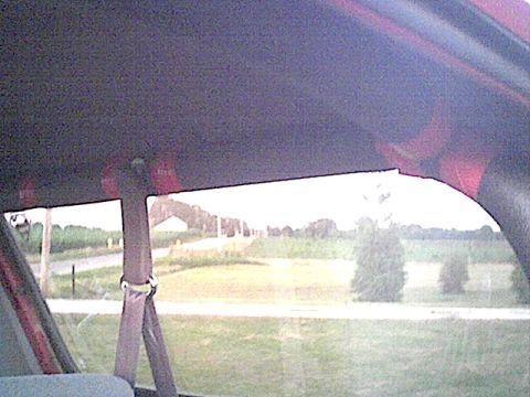 1994 Ford Bronco - View from the rear interior of a 1994 Ford Bronco, looking out at a rural landscape.