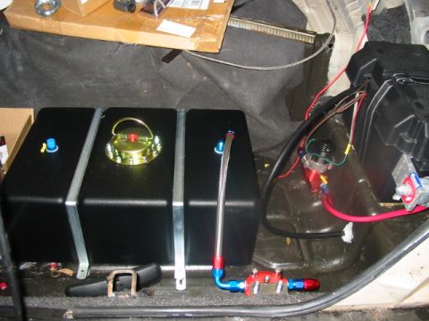 1985 Ford LTD Crown Victoria - Trunk interior shows custom fuel tank installation with associated plumbing and battery setup.