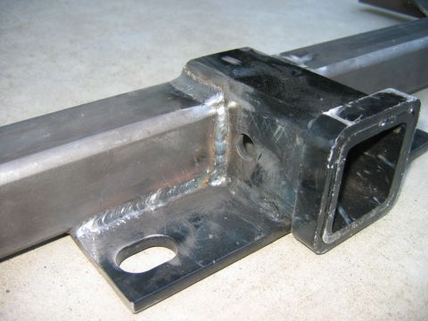 1985 Ford Bronco - This image shows a close-up view of a tow hitch receiver, highlighting its construction and mounting points.