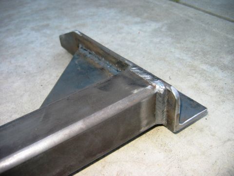 1985 Ford Bronco - A close-up view of a custom-fabricated steel component, likely a tow hitch bracket, showing extensive welding.
