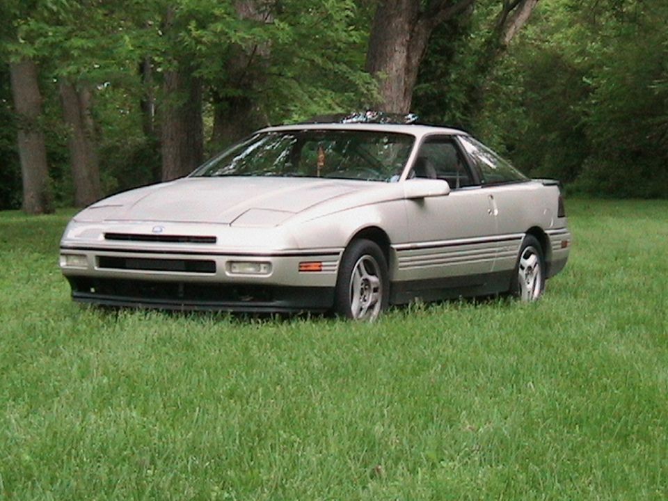 Silver 1989 Ford Probe GT parked in grass, 3/4 front view