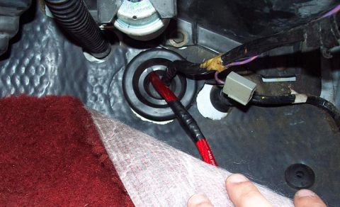 1985 Ford LTD Crown Victoria - Detail of automotive wiring and a grommet, likely from the trunk area.