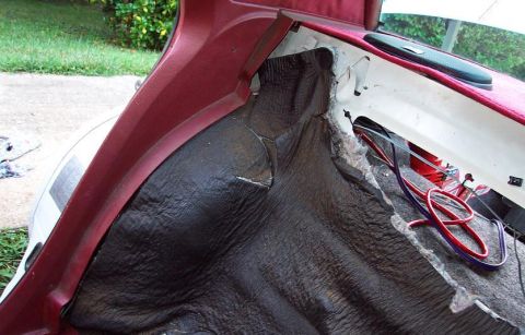 1985 Ford LTD Crown Victoria - Close-up view of the interior of a car trunk, showing exposed insulation and wiring.