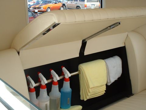 1999 Ford Crown Victoria - Cleaning supplies and towels are neatly organized inside a vehicle's storage area.