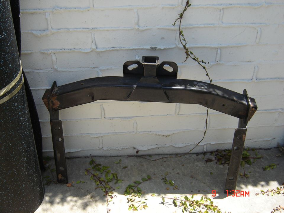 Tow hitch receiver mounted on a white brick wall