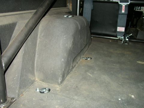1995 Ford Bronco - Interior view of a vehicle showing tie-down points and part of a roll cage.