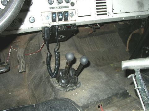 1995 Ford Bronco - The interior of a 1978 Ford Bronco, a CB radio and dual-stick shifters.