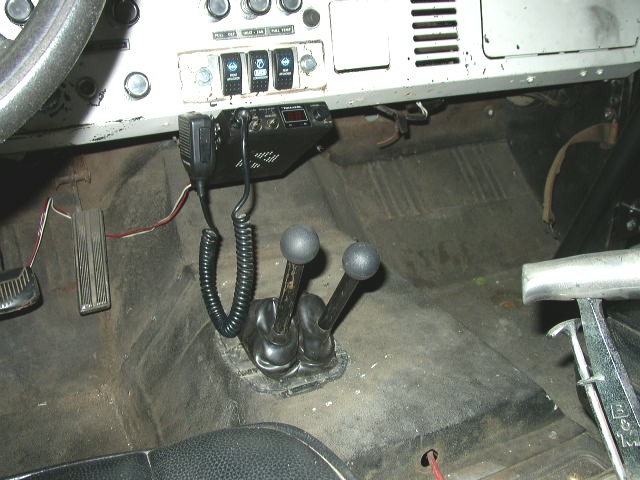 Interior view of a 1978 Ford Bronco showing the dashboard, floor shifter, and pedals
