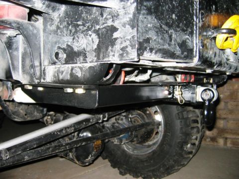 1985 Ford Bronco - Close-up of a rear tow hitch assembly, showing the shackle and wiring connection.