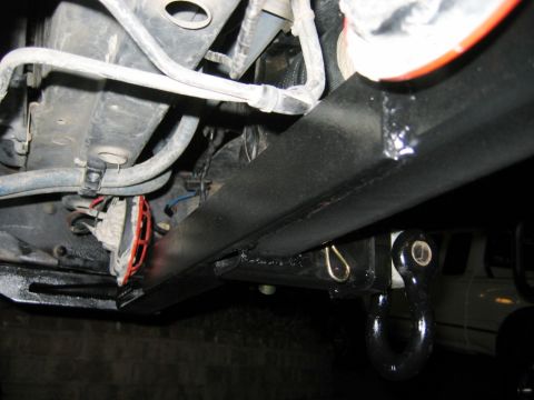 1985 Ford Bronco - Underside view of a vehicle's tow hitch receiver and attached shackle.