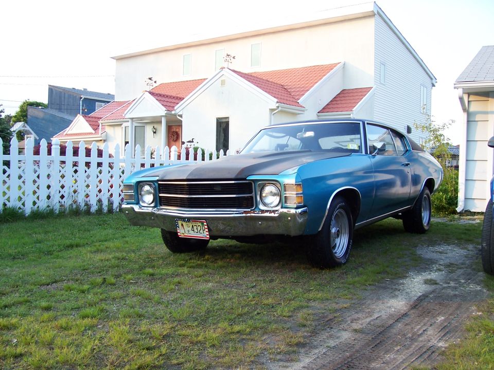 Blue 1970 coupe with black hood stripe and chrome bumper