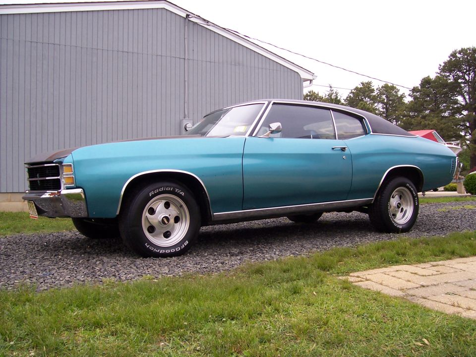 Teal 1971 Chevrolet Chevelle coupe with a black vinyl roof, seen from the side