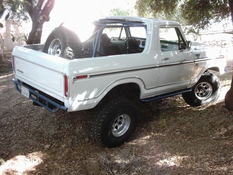 1978 Ford Bronco - This modified 1978 Ford Bronco features a roll cage and large off-road tires, ready for adventure.