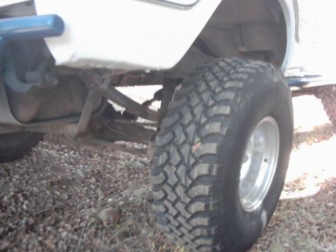 1978 Ford Bronco - Detail shot of a vehicle's undercarriage, focusing on the tire and suspension.