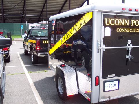 2001 Ford Crown Victoria - A UConn Police trailer and pickup truck are parked in a lot, possibly at an event.