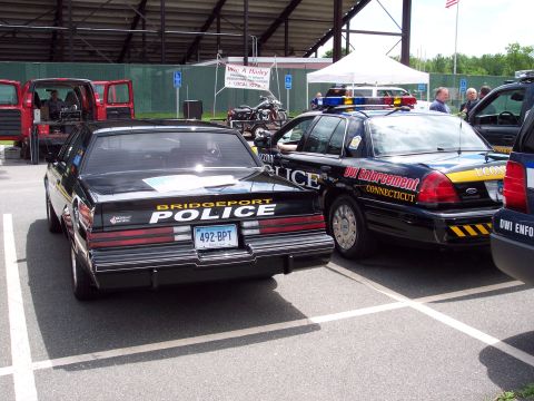 2001 Ford Crown Victoria - A car show features several police vehicles, including a Bridgeport Police car and a DUI Enforcement car.