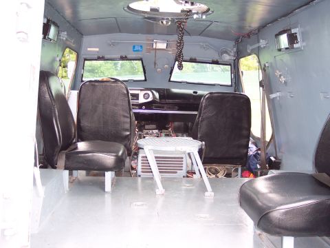 2001 Ford Crown Victoria - The interior of a utilitarian vehicle shows a basic dashboard and seating arrangement.