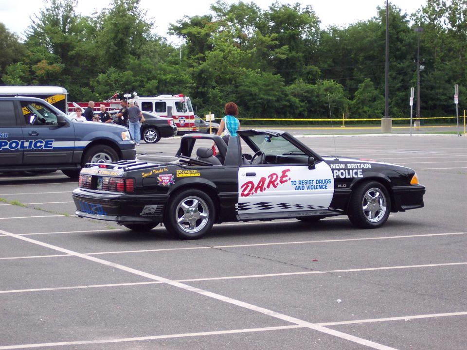 Black and white convertible police car with D.A.R.E. livery and "New Britain Police" text
