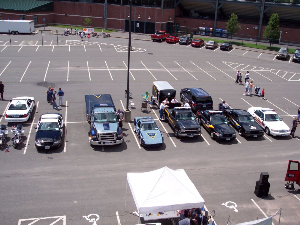 Several police vehicles, including a 2001 Ford Crown Victoria, parked in a lot