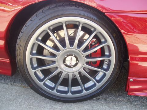 1993 Ford Taurus - A close-up view of a car's wheel and braking system, highlighting custom modifications.