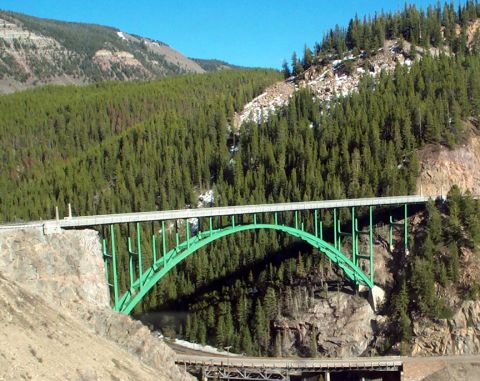 1996 Ford Bronco - A large green arch bridge crosses a deep gorge, with a smaller bridge visible below.