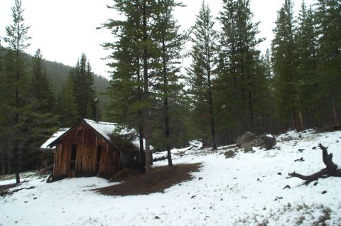 1996 Ford Bronco - Remote wooden cabin in a snow-covered forest landscape.